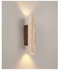 Aplique de pared cilíndrico de travertino con luz hacia arriba y abajo